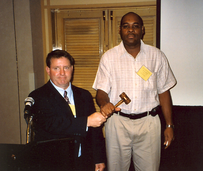 Rob Meagher handing gavel to incoming President, Oscar Liburd