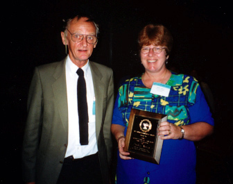 Judy Nova receives the Annual Achievement Award for Teaching from Howard Frank