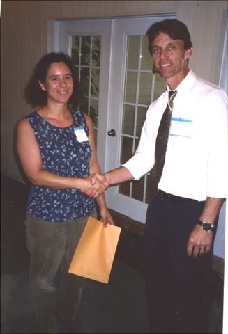 Laura Sirot receives the first place prize in the student presentation from Gregg Nuessly