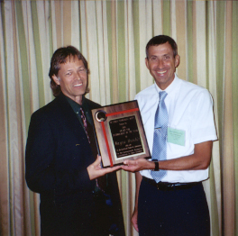 Wayne Hunter receives Entomologist of the Year Award from Rudi Scheffrahn
