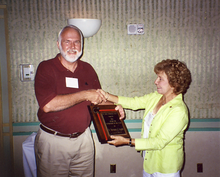 Norm Leppla receiving Entomologist of the Year award from Geri Cashion